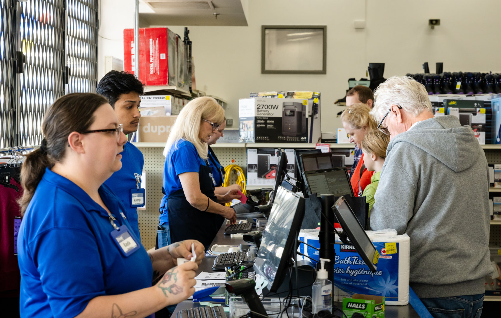 Big Box Oultet staff helping customers at the cash register